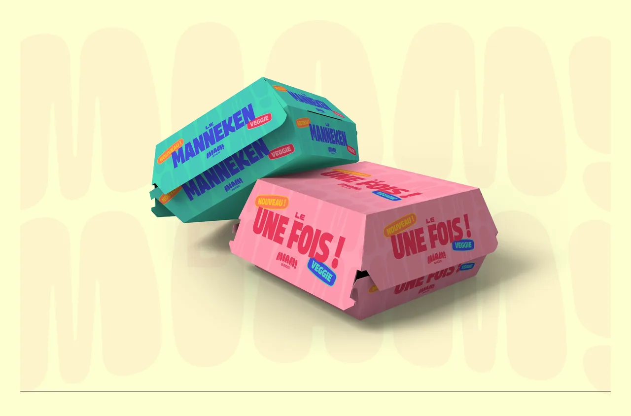 Deux boîtes à burger Miam! Burger, la verte « Le Manneken » et la rose « Le Une fois ! », chacune marquée « Veggie »