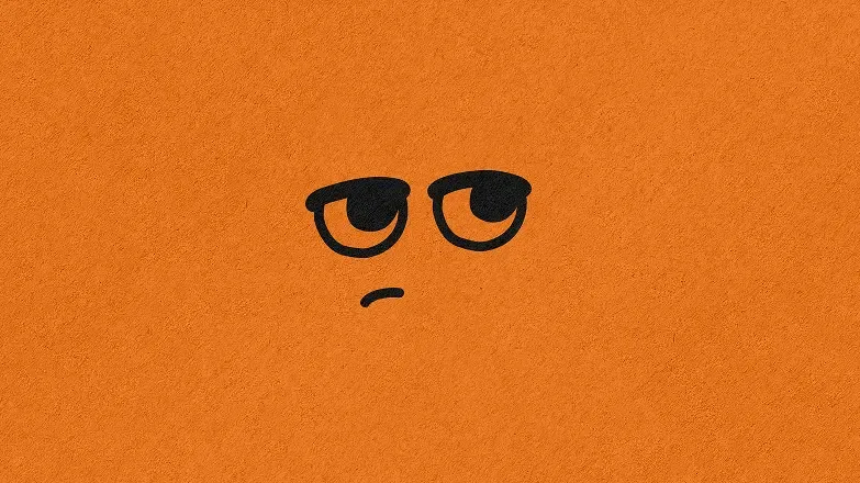 Mascotte Parko, deux yeux ronds et une bouche boudeuse dessinés en noir sur fond orange